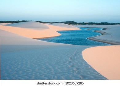 Lagoons in the desert of Lencois Maranhenses National Park, Brazil, low, flat, flooded land, overlaid with large, discrete sand dunes with blue and green lagoons