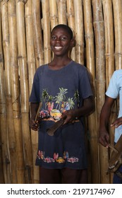 Lagos Nigeria: August 30, 2022- A Young Nigerian Boy Holding A Sound Instrument Gong Of The Yoruba Speaking Community Of West Africa.