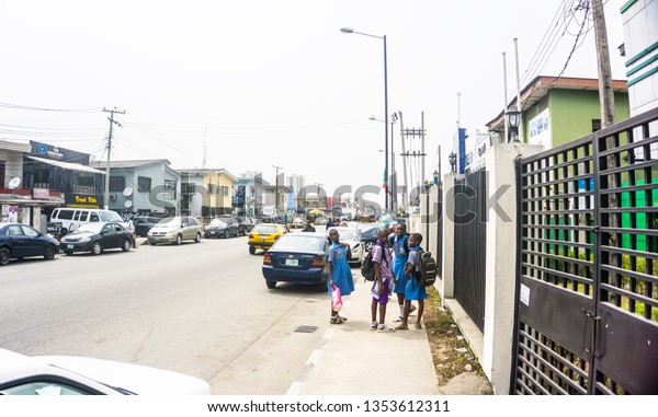 Lagos Nigeria,\
February 15 2019 - A busy afternoon on Bode Thomas street - with\
vehicles, buildings and\
people