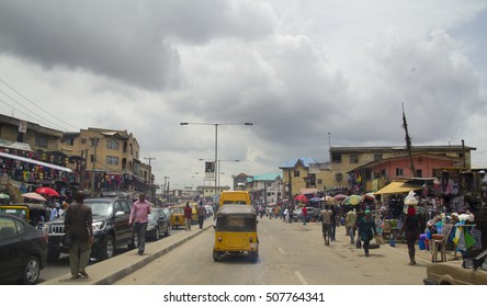 LAGOS, NIGERIA - MAY 11, 2012: People In The Street In The City View Of Lagos, The Largest City In Nigeria And The African Continent. Lagos Is One Of The Fastest Growing Cities In The World