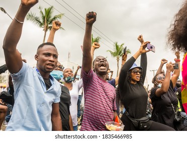 LAGOS, NIGERIA- OCTOBER 16, 2020: Nigerian Youths Take A Knee During A Protest Against Police Brutality In Lagos, Nigeria.