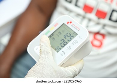 Lagos Nigeria West Africa-October 5 2022: An Equipment Holdings By A Doctor And Nurse Medical Practitioners To Test The Blood Pressure Of A Patient In Hospital