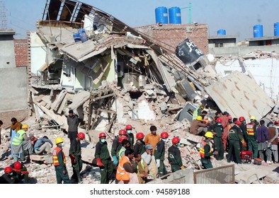 LAHORE, PAKISTAN - FEB 07: Rescue workers busy in rescue operation during the second day at the site of building collapse incident on February 07, 2012 in Lahore.