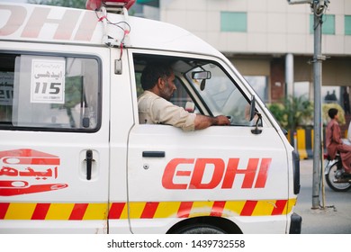 LAHORE, PAKISTAN - October 06, 2014: Edhi Ambulance Driver Rushes Injured Civilian To Hospital.