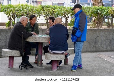 Lai Chi Kok, Hong Kong - 11 February 2018: Senior Citizens Play Chess With Their Friends In A Park Inside A Public Housing Estate.