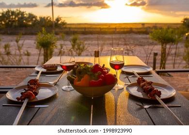 Laid Table With Food On The Summer Terrace.Food On The Terrace At Sunset.Dinner At Home With Friends During Sunset.Family Friendly Dinner At Home.Dinner Terrace For The Family.Wine With Meow At Sunset