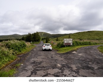 Lajes das Flores, Flores Island - May 21, 2021: Car stopped at an intersection, with several destination options to explore Flores Island, on a road trip.
