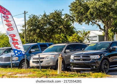 Lake Alfred, USA - October 19, 2021: Local Used Car Auto Dealer Dealership With Cars Parked On Parking Lot Display With Price Tags On Windshield Windows In Florida Small Town City