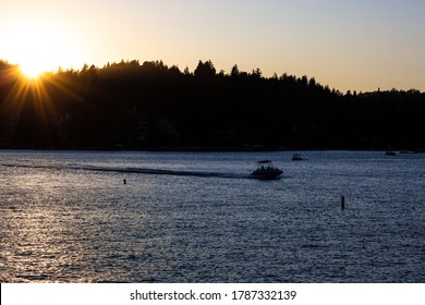 Lake Arrowhead, California - August 8 2019: A Boat Speeds Across The Lake During Sunset. 