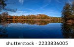 Lake in the autumn forest. Panorama of autumn forest lake. Forest lake in autumn. Autumn forest lake landscape