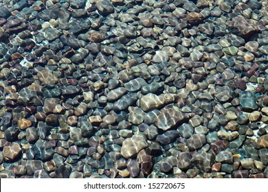 Lake Bed Of Rocks Or Pebbles Under Water.