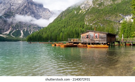 Lake Braies, Italy. Group Of The Traditional Rowing Boats Docked To The Wood House. Iconic Location For Photographers. Picturesque Mountain Lake In Dolomites. Wonderful Nature Contest. Alpine Lake