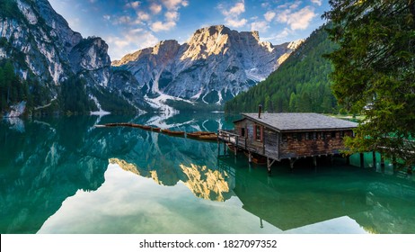 Lake Braies (Lago di Braies) in Dolomites Mountains, Boat hut on Braies Lake with Seekofel mount on background, Sunrise of Italian Alps, Naturepark Fanes-Sennes-Prags, Dolomite, Italy, Europe.