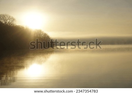 LAKE WITH BRIGHT GOLDEN SUNUP