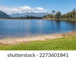 Lake Brunner (Moana) shoreline with Hohonu range and ancient podocarp trees in background, West Coast, South Island, New Zealand