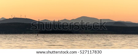 Lake Champlain in Vermont at sunset with mountains in the background