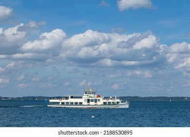Lake Chiemsee, Bavaria, Germany - 10th June 2022: A german photographer visiting a lake in the bavarian alps during summer time. A steam boat ariving in Gstadt.