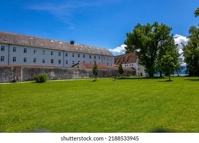 Lake Chiemsee, Bavaria, Germany - 10th June 2022: A german photographer visiting a lake in the bavarian alps during summer time. View across a meadow to the monastery Frauenchiemsee.