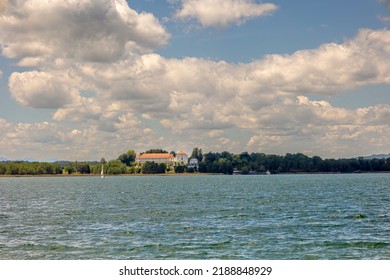 Lake Chiemsee, Bavaria, Germany - 10th June 2022: A german photographer visiting a lake in the bavarian alps in summer time. View from the island called Fraueninsel to the island called Herreninsel.