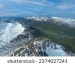 Lake Clark National Park in Alaska. Drift River Valley in Chigmit Mountains and Aleutian Range. Braided alpine rivers full of snowmelt. Aerial view over rugged and remote mountains. 