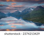 Lake Clark National Park, Alaska. Mountains and sunrise or sunset reflect on Lake Clark. 