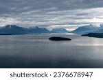 Lake Clark in Lake Clark National Park and Preserve in Alaska. Turquoise lake with rugged mountains, islands and shore. Denaʼina: Qizhjeh Vena. Tommy Island.