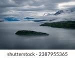 Lake Clark in Lake Clark National Park and Preserve in Alaska. Turquoise lake with rugged mountains, islands and shore. Denaʼina: Qizhjeh Vena. Tommy Island. 