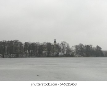 The lake covered with ice. Cold winter . Nesvizh Castle is a residential castle of the Radziwill family. View of the castle in winter  - Shutterstock ID 546821458
