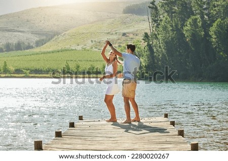 Lake, dancing and happy nature couple on outdoor quality time together, fun countryside adventure or bonding getaway. Freedom peace, water and playful woman, man or romantic people dance on love date
