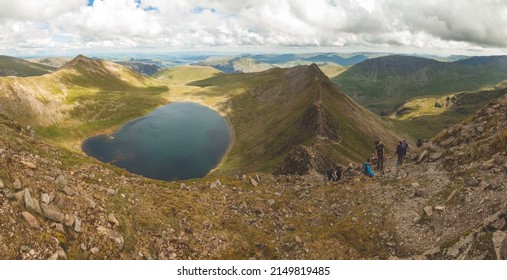 Lake District, England - May 26, 2014: Natural landscape from Helvellyn Edge, and small lake Red Tarn, in the Lake District National Park, northern England, Cumbria county, UK