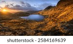 Lake District mountains at sunrise with panoramic view of Stickle Tarn, overlooking Pavey Ark and Southern Fells.