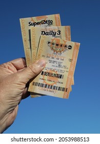 Lake Elsinore, California - May 20, 2021: A Man's Hand Holding A Variety Of Lottery Tickets.