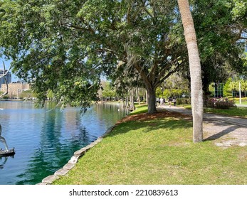 Lake Eola Park In Downtown Orlando, Florida. Large Commercial Buildings In The Background.