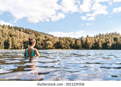 Lake In Finland. Woman Swimming. Finnish Nature, Water And Serene Sky In Summer. Outdoor Bathing In Scandinavia After Sauna. Green Forest And Beach In The Morning Or Day. Lakeside Back View Portrait