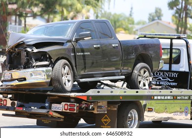 Lake Forest, California, May 23, 2017: A Flat Bed Tow Truck Removes And Halls Away A  Pool Service Truck After Causing An Accident Causing Hazmat To Respond And Clean Up Hazardous Chemicals.