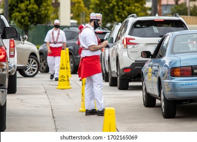 Lake Forest, CA/USA-04/10/20: Workers At Drive Through Restaurant Maintaining Social Distance 