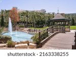 A lake with fountains, a bridge and a gazebo in Gan HaMoshava Park in Rishon Lezion