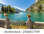 Lake Garda with mountains in background, view from Riva del Garda town shore, Italy, Europe.