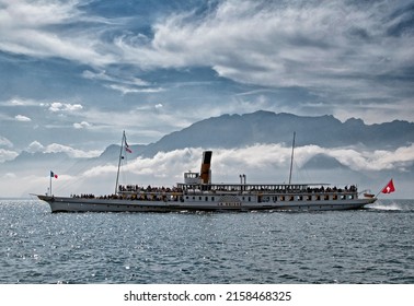 Lake Geneva, Switzerland, Europe - 09.23.2012 : historic steamboat cruise, Lac Leman near Montreux, Swiss Riviera, French Alps in the background