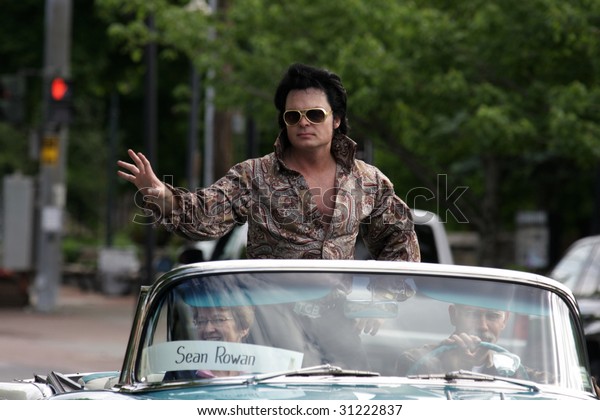 LAKE GEORGE, NY - MAY 30 :\
An Elvis impersonator rides in the Elvis Classic Car Parade during\
the 2009 Lake George Elvis Festival May 30, 2009 in Lake George,\
NY.
