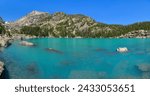 Lake Haiyaha - A panoramic view of colorful lake Haiyaha, with Hallett Peak towering at shore, on a sunny and calm Summer day. Rocky Mountain National Park, Colorado, USA.