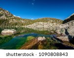 Lake Haiyaha with rocks and mountains in snow around at autumn. Rocky Mountain National Park in Colorado, USA. 