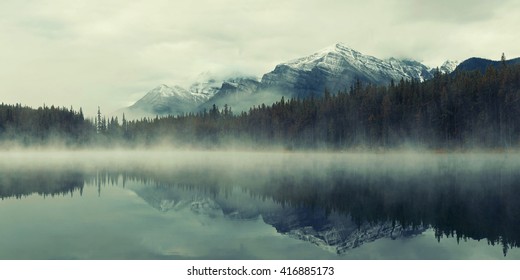 Lake Herbert panorama in a foggy morning with glaciers mountain and reflection in Banff National Park, Canada