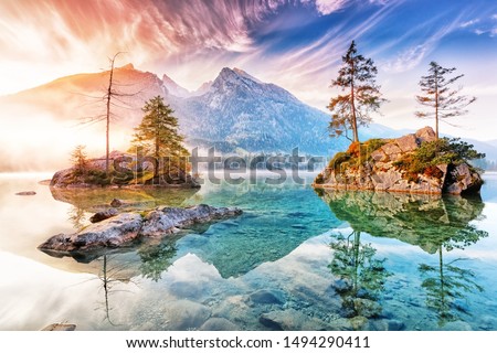 Lake Hintersee in Germany, Bavaria, National Park Ramsau in Alps. Beautiful autumnal Alpine landscape, amazing light during sunrise. Incredible seasonal autumn scenery. Famous landmark in Germany.