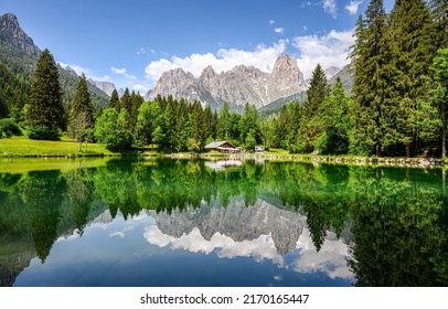 Lake house in mountains. Mountain lake landscape. Beautiful mountain lake view. Lake water reflection in mountains - Shutterstock ID 2170165447
