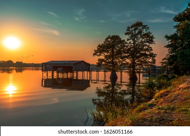 Lake House And Pier At Sunset