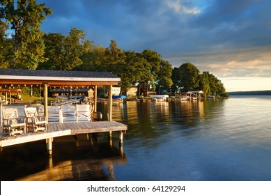 Lake house with pier and woods with sunrise in the morning in New York state Finger Lakes - Powered by Shutterstock