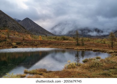 Lake Jack London. Gray Thick Clouds Over Snow-capped Peaks. Harsh Subarctic Climate.