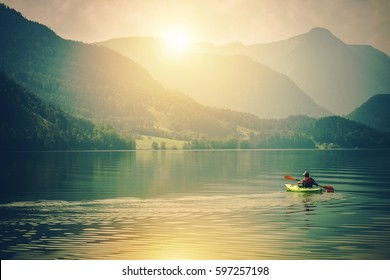 Lake Kayak Touring. Summer Recreations and Sport Photo Concept. Senior Sportsman in the Tour Kayak on the Lake. - Powered by Shutterstock