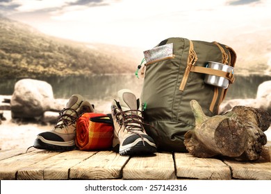lake landscape and big backpack with shoes 